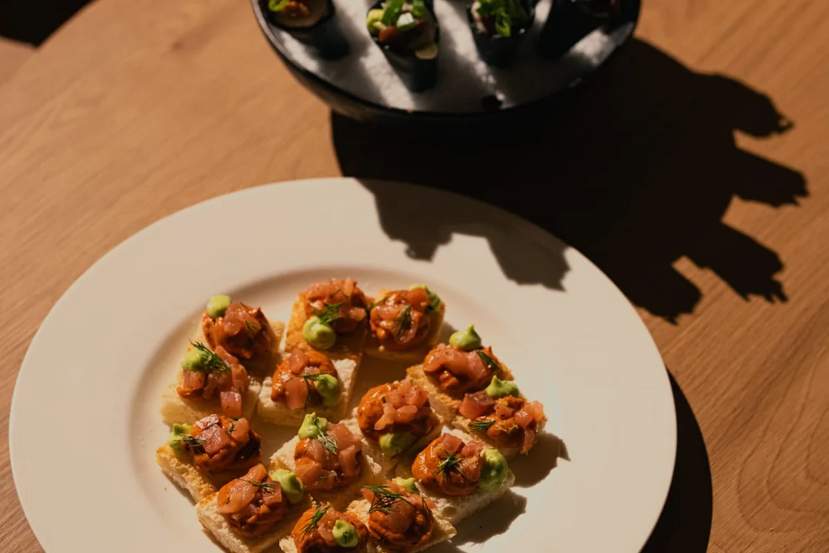 Canapés plated on a wooden table before service