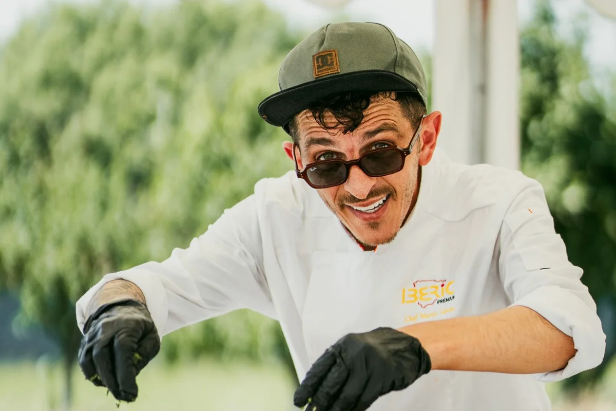 Marco Genna finishing a paella at an outdoor event